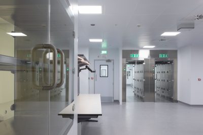 Modern PBSC cleanroom facility interior showing pass-through hatches and decontamination chambers.